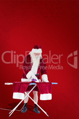 Composite image of santa is ironing his pants
