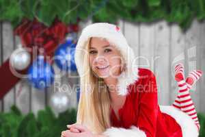 Composite image of festive blonde using tablet pc