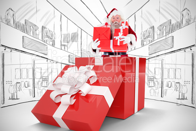 Composite image of santa standing in large gift