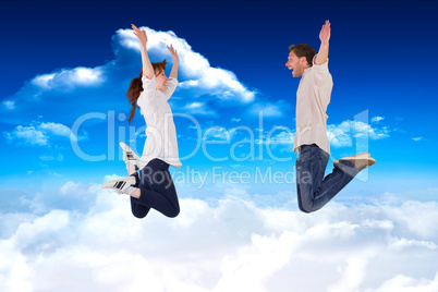 Composite image of couple jumping in the air