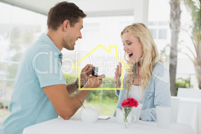 Composite image of man proposing marriage to his shocked blonde