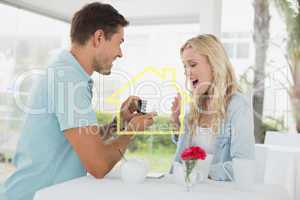 Composite image of man proposing marriage to his shocked blonde