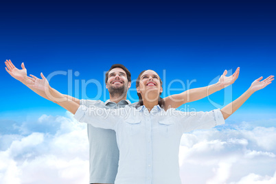 Composite image of cute couple standing with arms out