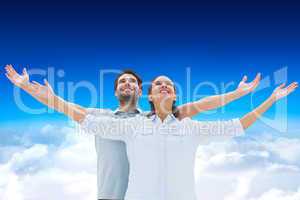 Composite image of cute couple standing with arms out