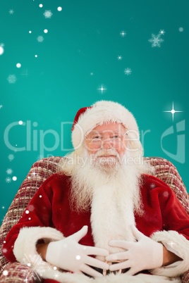 Composite image of santa holding his belly on the armchair