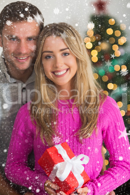 Composite image of happy couple holding each other