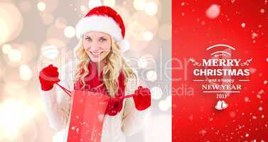 Composite image of happy festive blonde with shopping bag