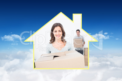 Composite image of pretty woman holding boxes in her new house