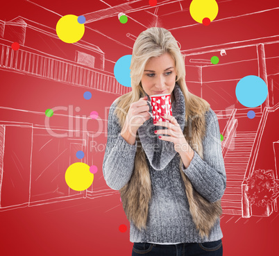 Composite image of woman in winter clothes holding a mug