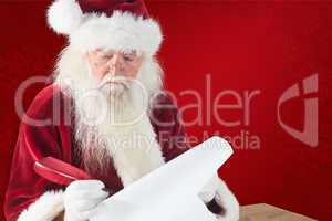 Composite image of santa writes something with a feather