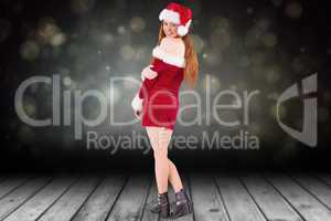 Composite image of festive redhead smiling at camera