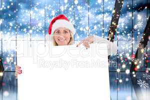 Composite image of festive blonde showing white poster