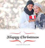 Composite image of happy winter couple with gift