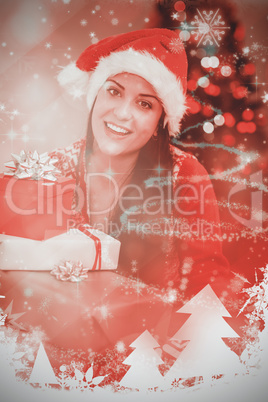 Composite image of festive brunette smiling at camera