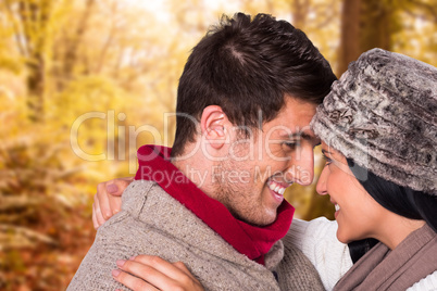 Composite image of young couple smiling and hugging