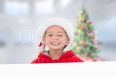 Composite image of festive little girl showing poster