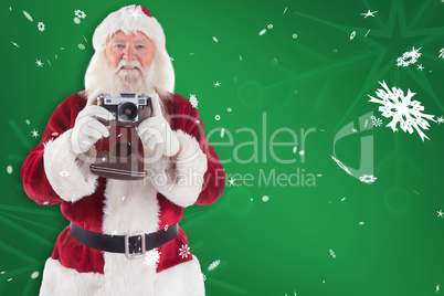 Composite image of santa is taking a picture