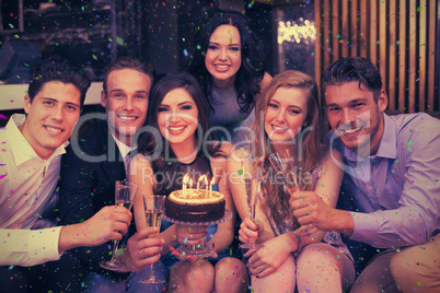 Composite image of attractive friends celebrating a birthday