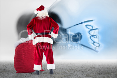 Composite image of santa with sack of gifts