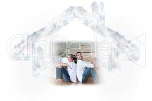 Composite image of glowing couple sitting on the floor
