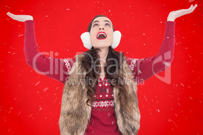 Composite image of brunette in winter clothes with hands out