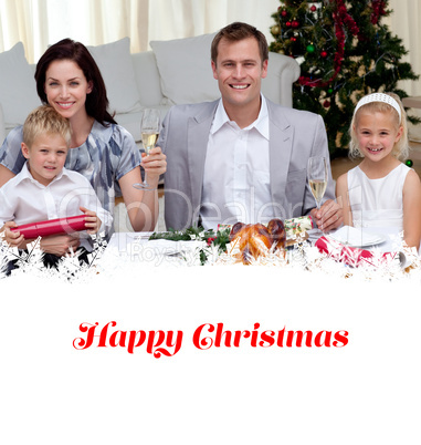 Composite image of parents toasting with champagne in christmas