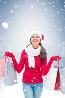 Festive brunette holding shopping bags