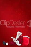 Composite image of santa sits leaned on his bag and has no clue