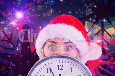 Composite image of festive blonde showing a clock