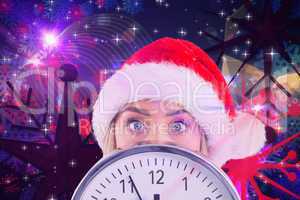 Composite image of festive blonde showing a clock