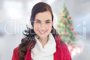 Composite image of portrait of a smiling brunette with winter we