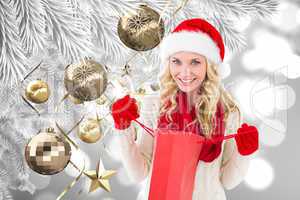 Composite image of happy festive blonde with shopping bag