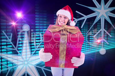 Composite image of festive young woman holding a gift