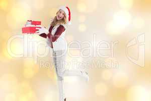 Composite image of smiling blonde in warm clothing holding pile