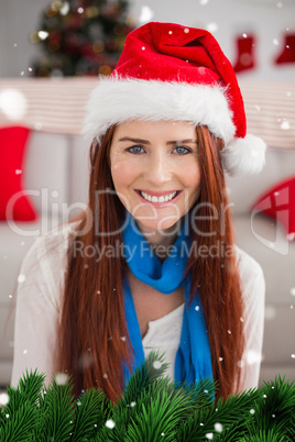 Composite image of festive redhead smiling at camera