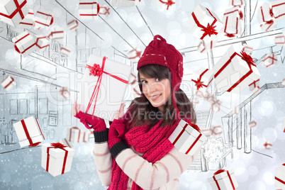 Composite image of smiling brunette showing a gift