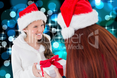 Composite image of mother and daughter with gift