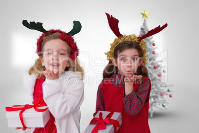 Composite image of cute girls with gifts