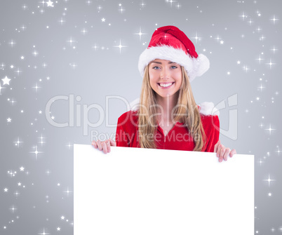 Composite image of pretty santa girl smiling at camera with post