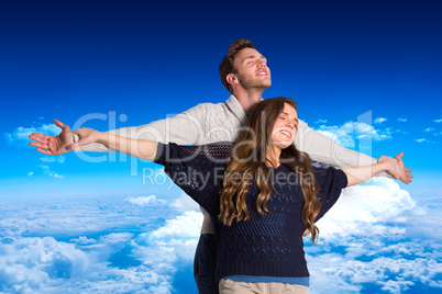 Composite image of romantic young couple with arms out