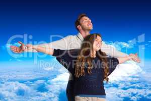 Composite image of romantic young couple with arms out