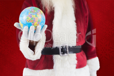 Composite image of santa has a globe in his hand