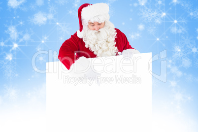 Composite image of cheerful santa claus presenting sign