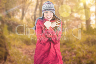 Composite image of cold redhead wearing coat and hat