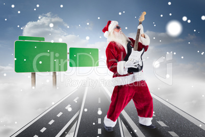 Composite image of santa playing electric guitar