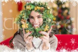 Composite image of brunette on the couch showing wreath at chris