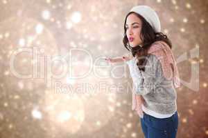 Composite image of pretty brunette in white hat blowing