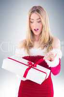 Pretty santa girl opening gift