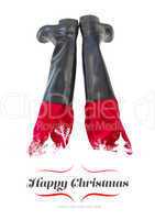 Composite image of lower half of santas legs with his black boot