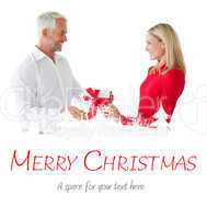 Composite image of smiling couple holding a gift